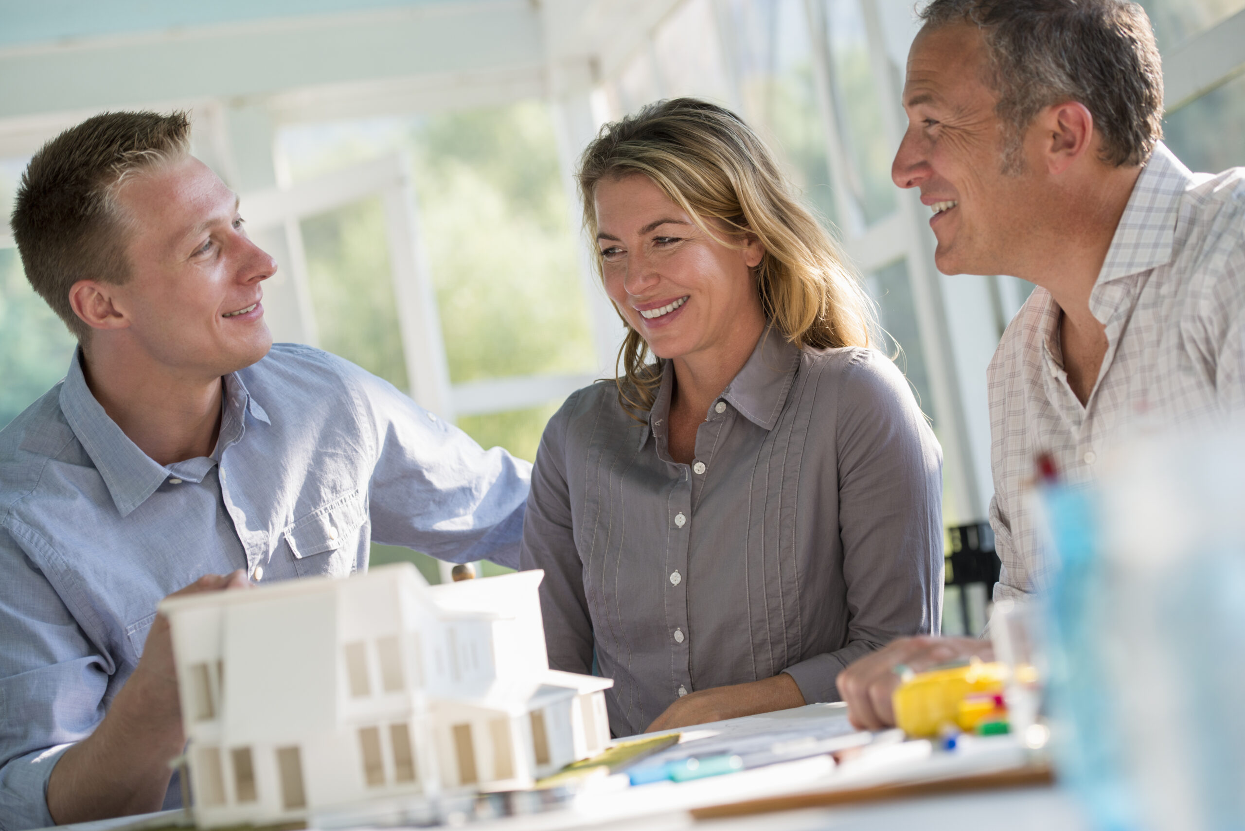 Couple meeting with Capstone Custom Homes builder to discuss home design