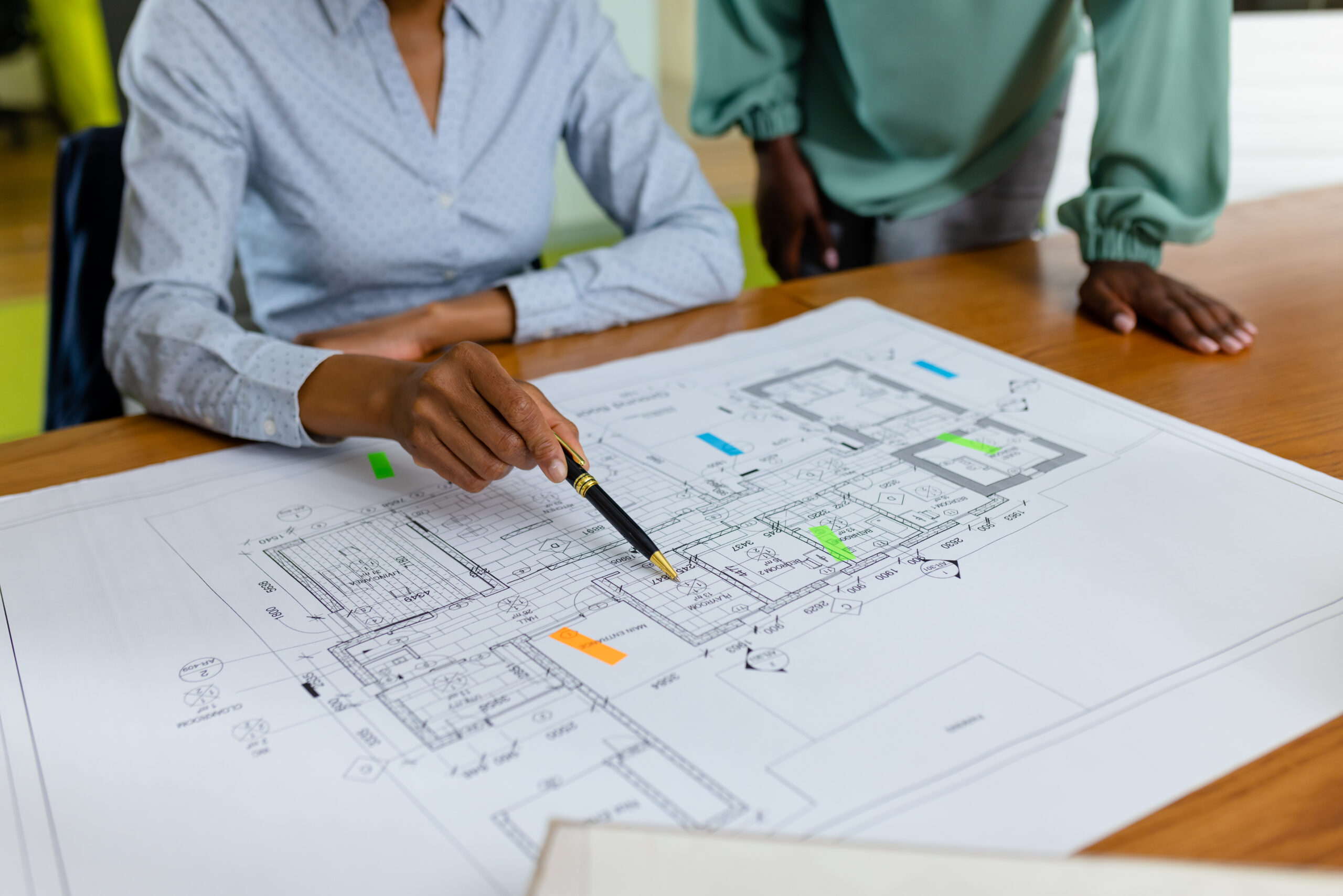 Architect reviewing house blueprints for Capstone Custom Homes project