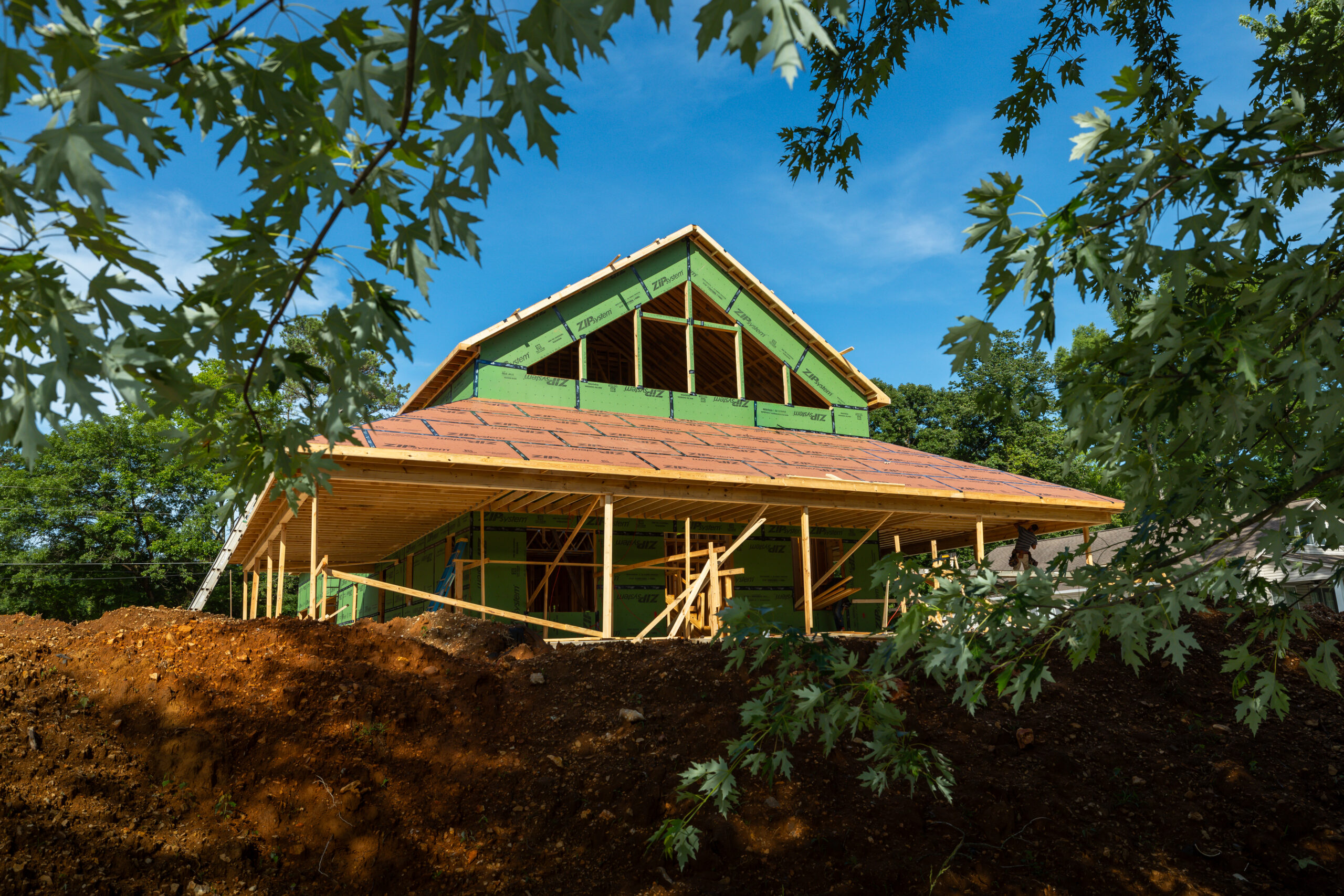 Custom riverfront home under construction in Rogersville Alabama with ZIP System sheathing and tall living room windows overlooking the water.