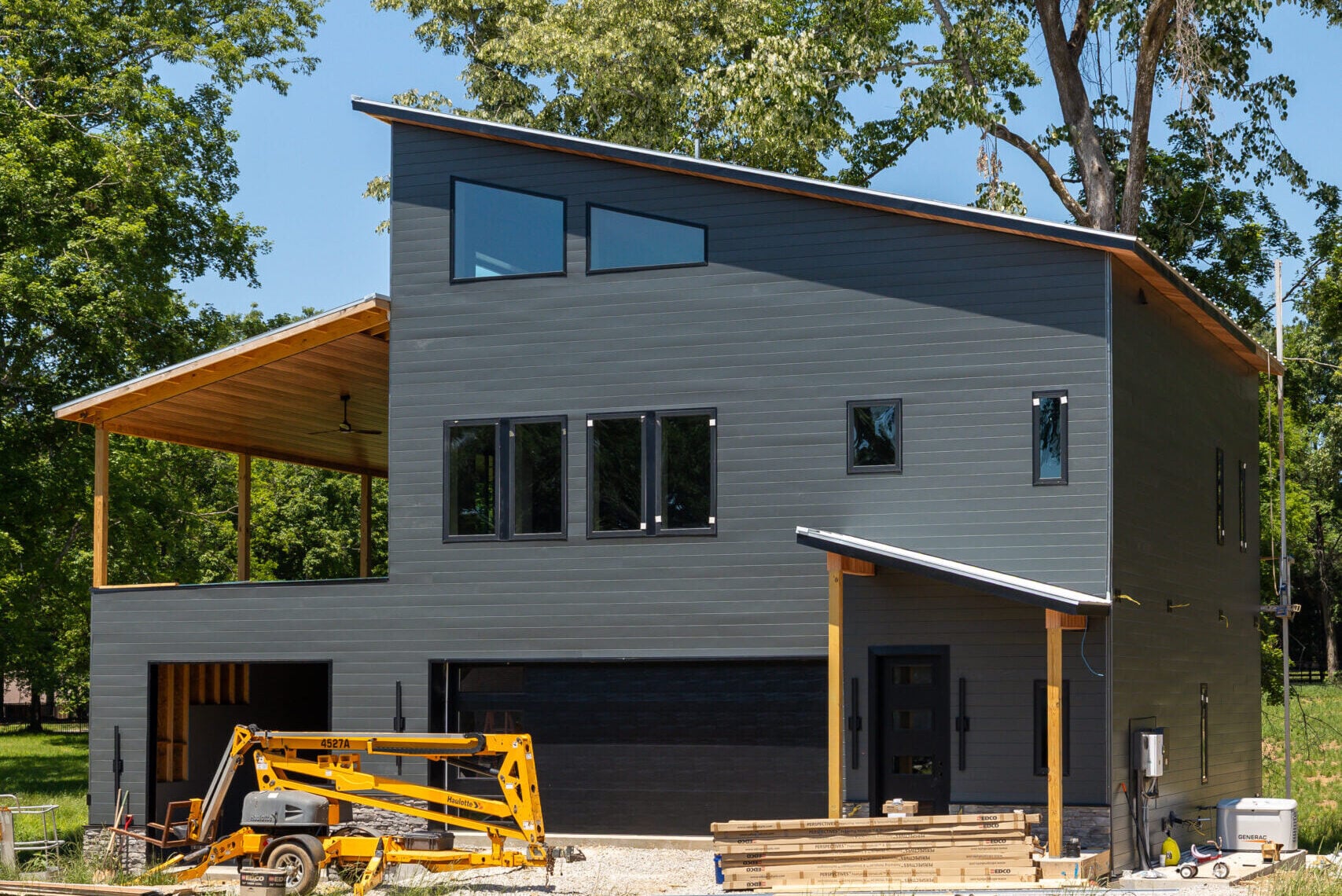 Energy efficient modern home in Rogersville Alabama with dark exterior finishes and clean contemporary design.